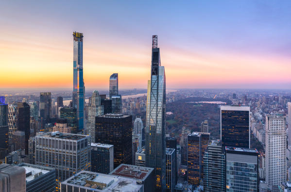 Northern side of Manhattan view from Top Of The Rock Building, with Central park on the background, during sunset. New York, USA.