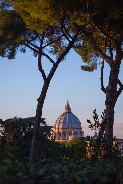 Rome, Lazio, Italy. View of Saint Peter Cathedral, trough the trees, during sunset.