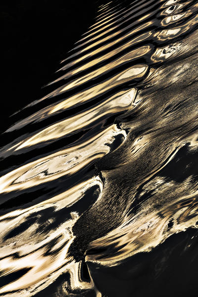 The wave pattern reflecting the sunset light in Rio Negro, amazon basin; manaus; brazil. Amazonas; Amazonia; Manaus; Brazil.