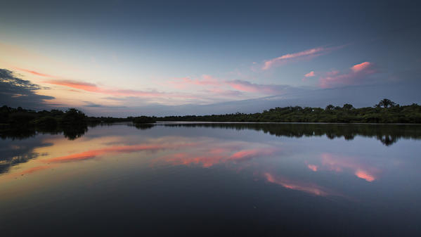 The rio negro waters depicted at sunrise, with the sky reflecting on a lagoon
Rio Negro, Amazonas; Amazonia; Manaus; Brazil.