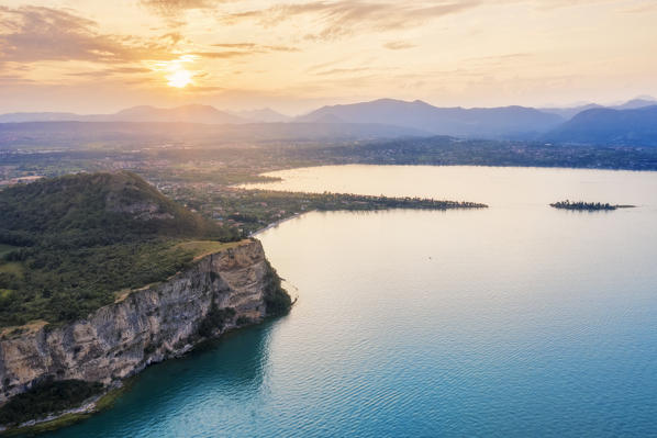 Aerial shot of the Rocca di Manerba, in the background you can see the Gulf of Manerba and the island of San Biagio. Manerba, Garda Lake, Province of Brescia, Italy