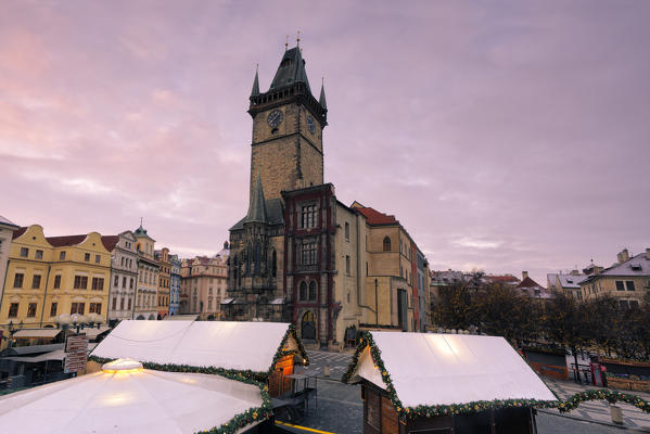 Prague, Czech RepublicThe clock tower in prague photographed at dawn, in the foreground Christmas stalls