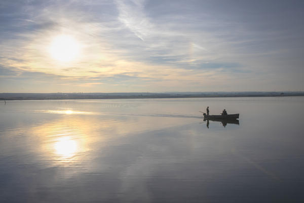 Fisherman in Lesina lake, Lesina village, Foggia district, Apulia, Italy