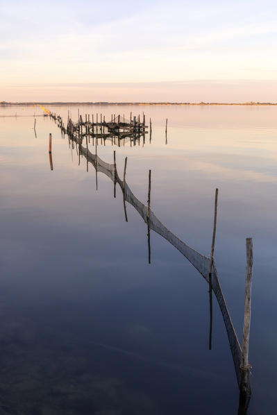 Lesina lake at sunset, Lesina village, Foggia district, Apulia, Italy