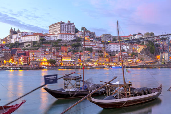 foto  - Dusk on Port wine boats moored on the south bank of Douro River, whit Porto old town on the background, Vila Nova de Gaia, Porto district, Norte Region, Portugal