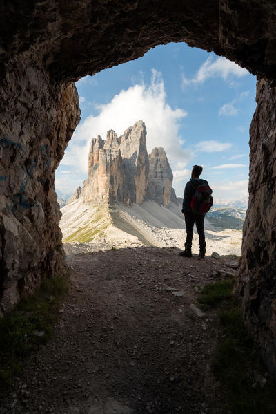 foto  - Europe, Italy, Dolomites, Veneto, Belluno. Hiker admire Tre Cime di Lavaredo from Trenches of the First World War on Mount Paterno