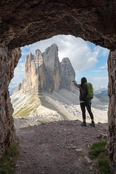 foto  - Europe, Italy, Dolomites, Veneto, Belluno. Woman hiker admire Tre Cime di Lavaredo from Trenches of the First World War on Mount Paterno