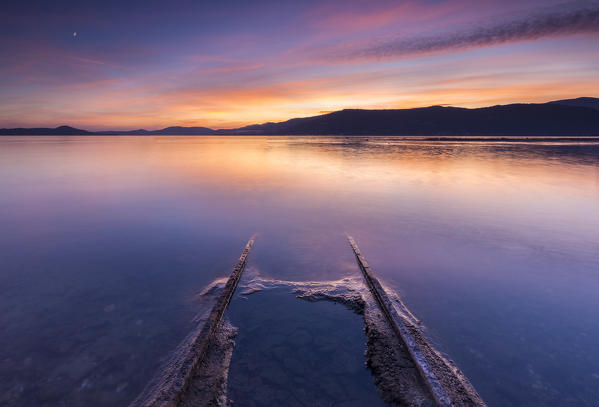 foto  - Emerged boat rails at Sasso Moro dock during an autumnal sunset, Sasso Moro, Leggiuno, Lake Maggiore, Varese Province, Lombardy, Italy.