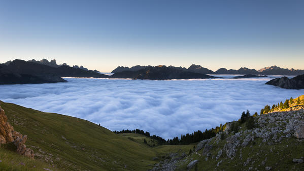 foto  - a suggestive sunrise from the Rosengarten Group with all the Fassa valley covered by clouds, Trento province, Trentino Alto Adige, Italy