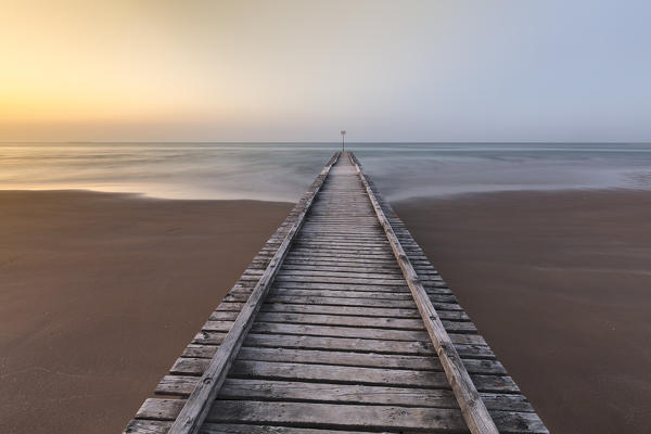 foto  - Europe, Italy, Veneto, Venice, Jesolo. A wooden pier on the beach towards adriatic sea